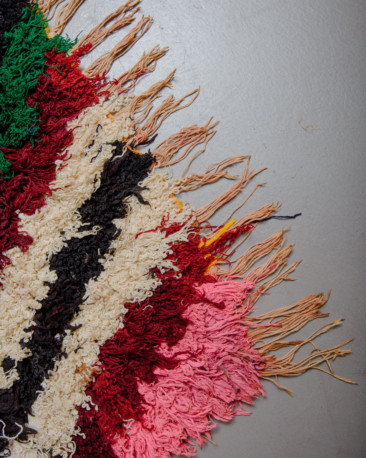 Corner of Boucherouite rug with cotton fringe.