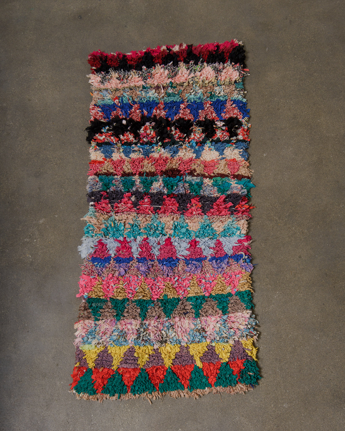 Colourful rug on cement floor. 