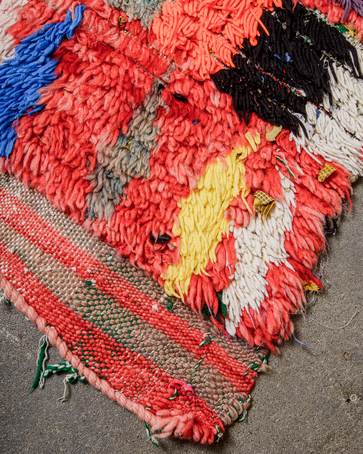 Colourful woven rug on a textured surface