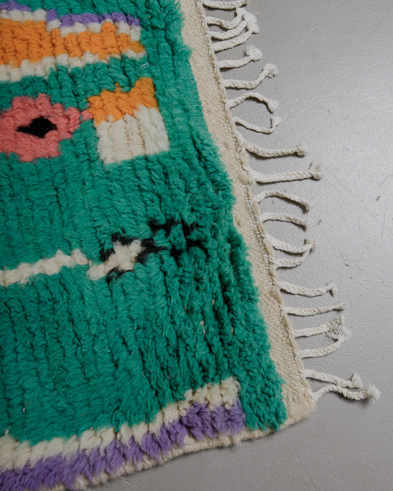 Corner of Boujaad runner rug with white cotton tassels. 