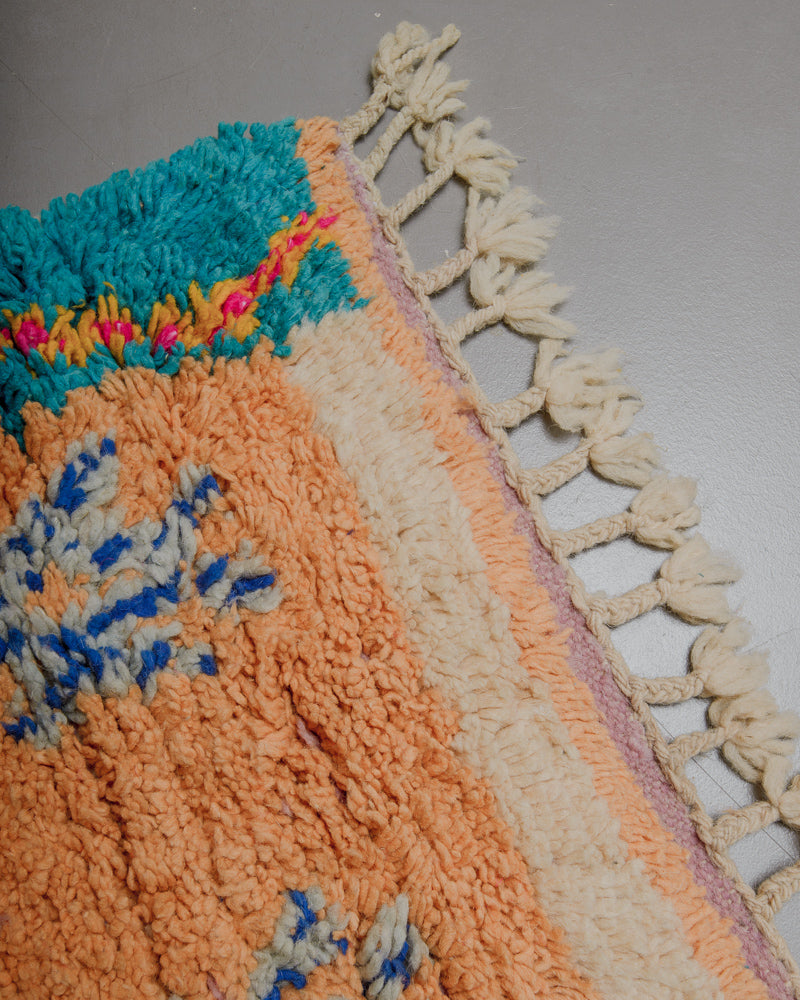 Corner of Boujaad runner rug with natural wool tassels. 