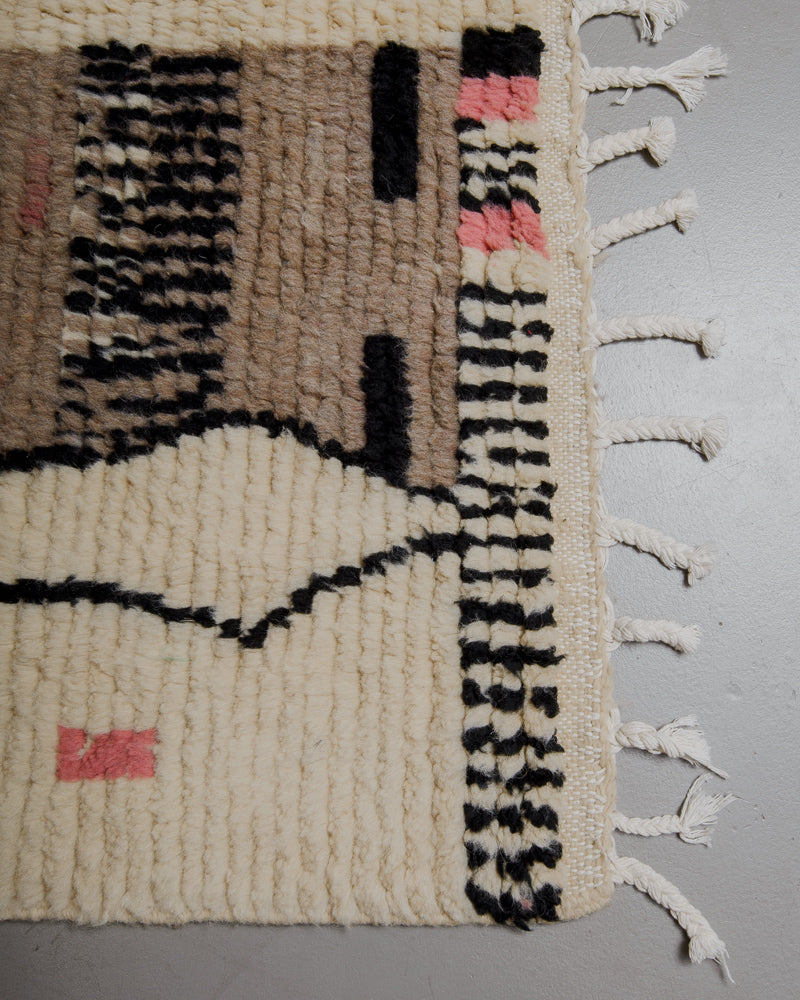 Corner of wool boujaad rug with white cotton tassels. 