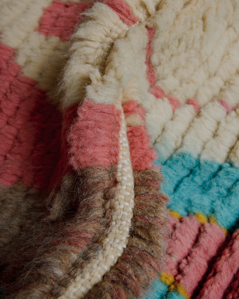 Close up of vintage boujaad rug showing depth of pile and cream, brown, pink and turquoise wool.