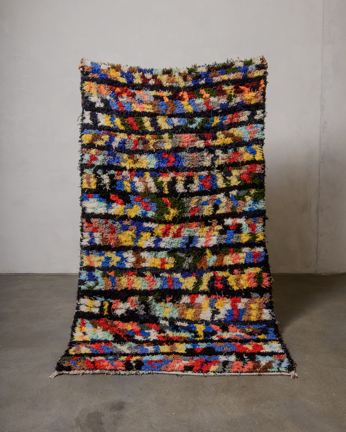 Multicolored woven rug on a plain background