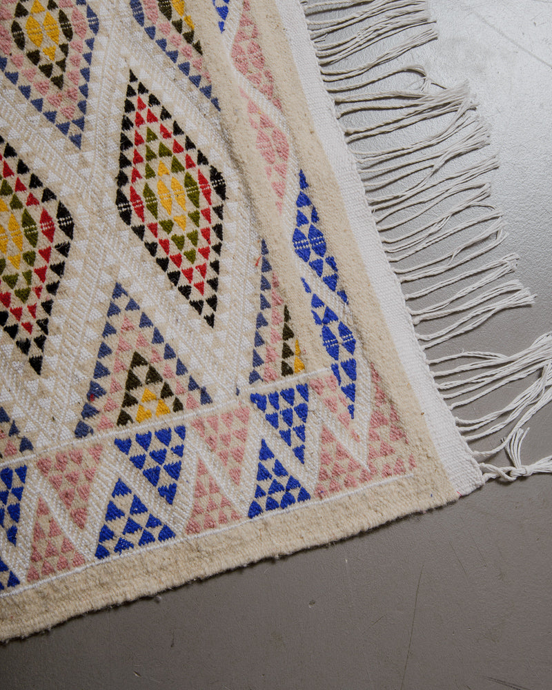 Corner of kelim rug.