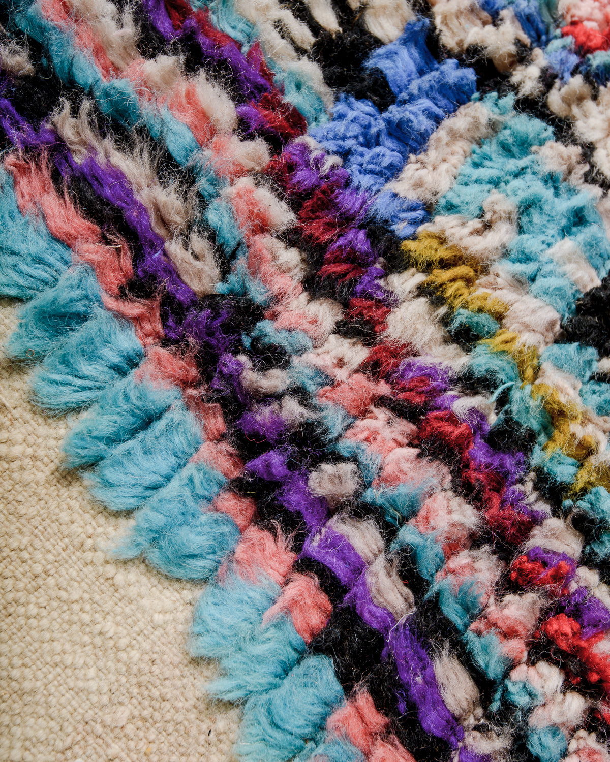 Detail of colourful wool pile on vintage runner.