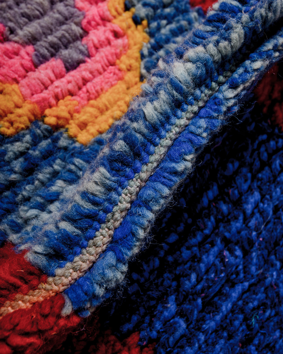 Detail of colourful wool pile on vintage runner.