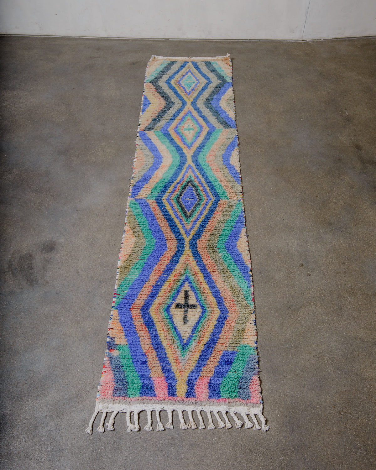 Colorful geometric patterned rug on a concrete floor