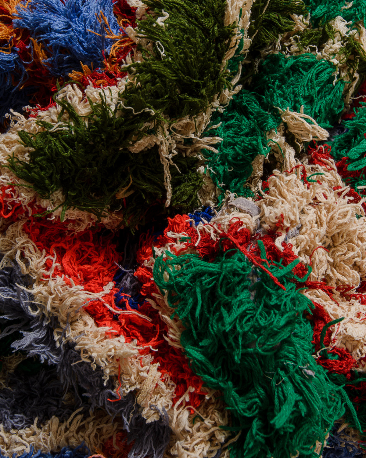Close-up of a textured rug with multicolour yarns