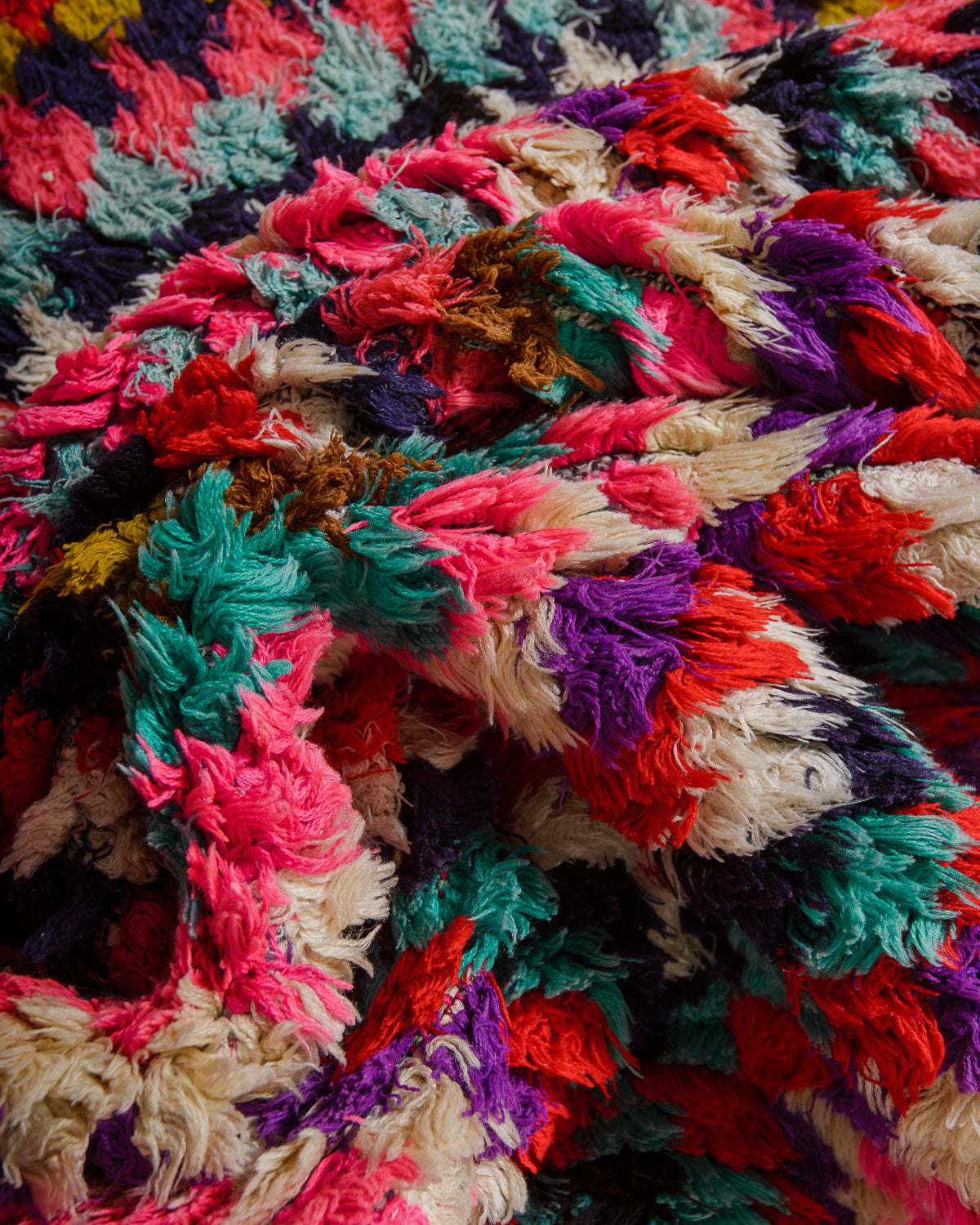 Close-up of a colorful woven fabric rug with multicolor pattern