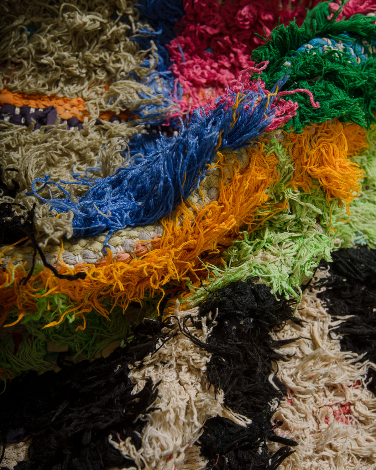 Close-up of colorful textured fabric with a rainbow pattern.