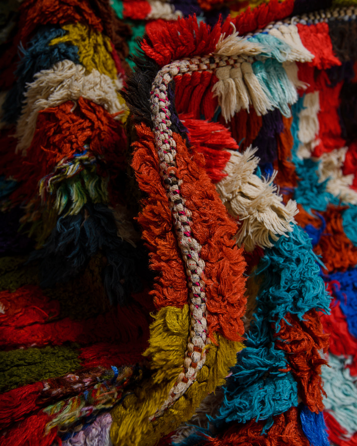 Close-up of a colorful textured fabric with fringes