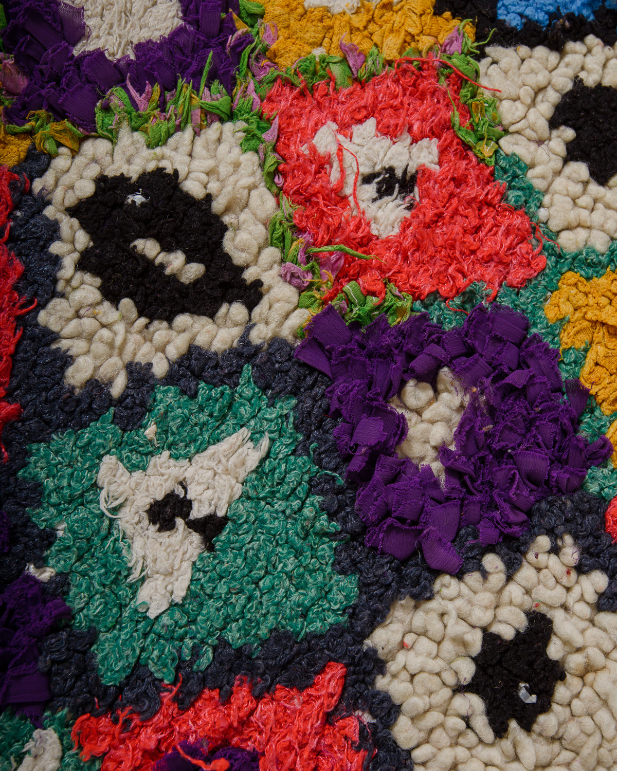 Close-up of a colourful patchwork rug with various colors.