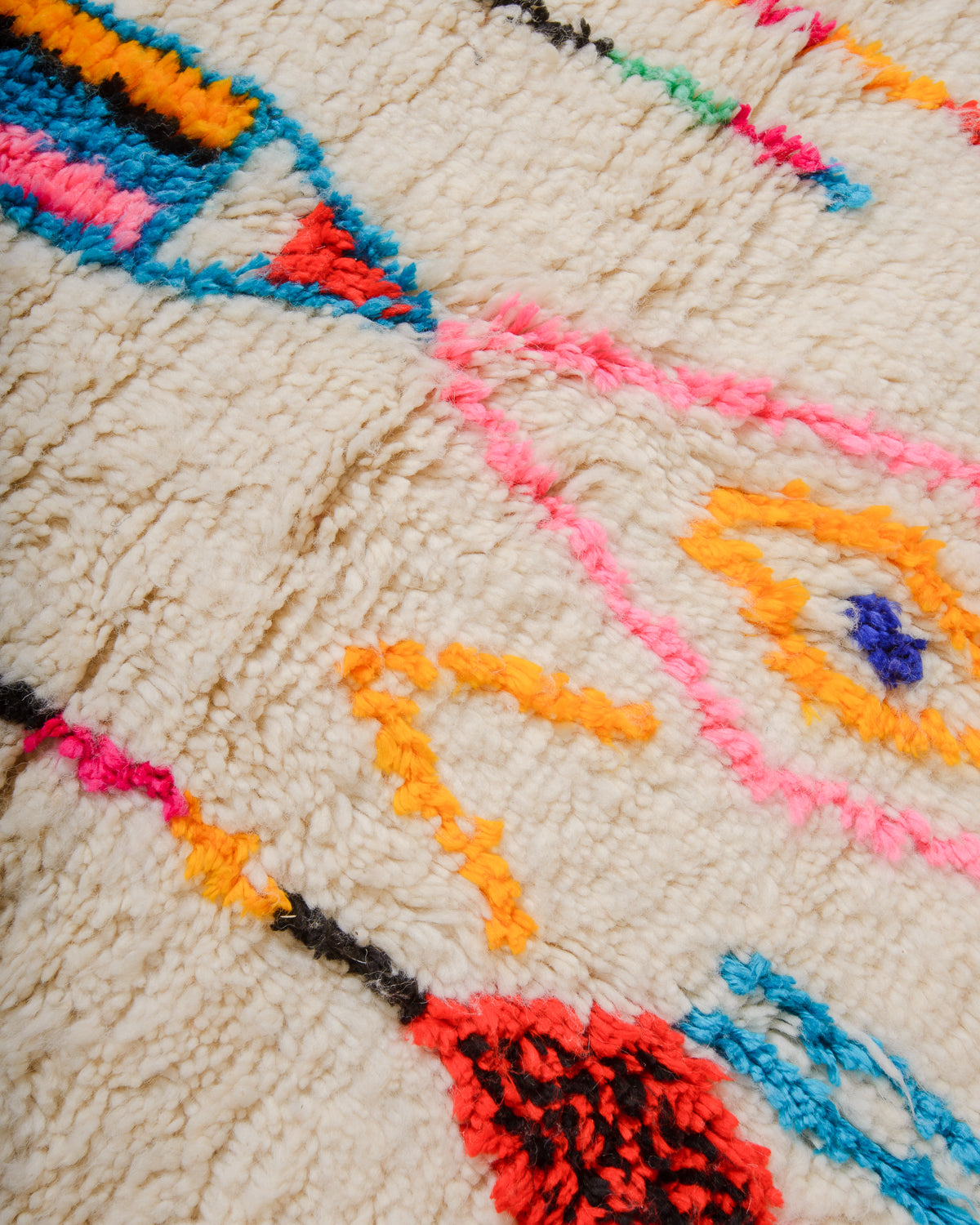 Close-up of a colorful woven textile with geometric patterns.
