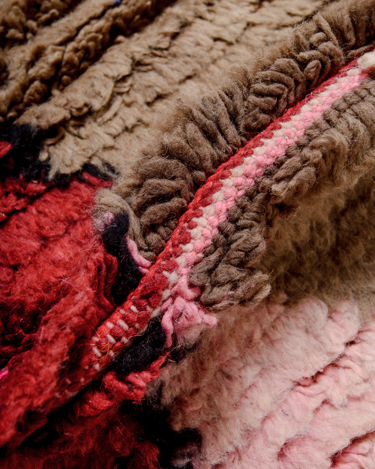 Detail of colourful berber rug showing the density of the knots and the length of the wool.