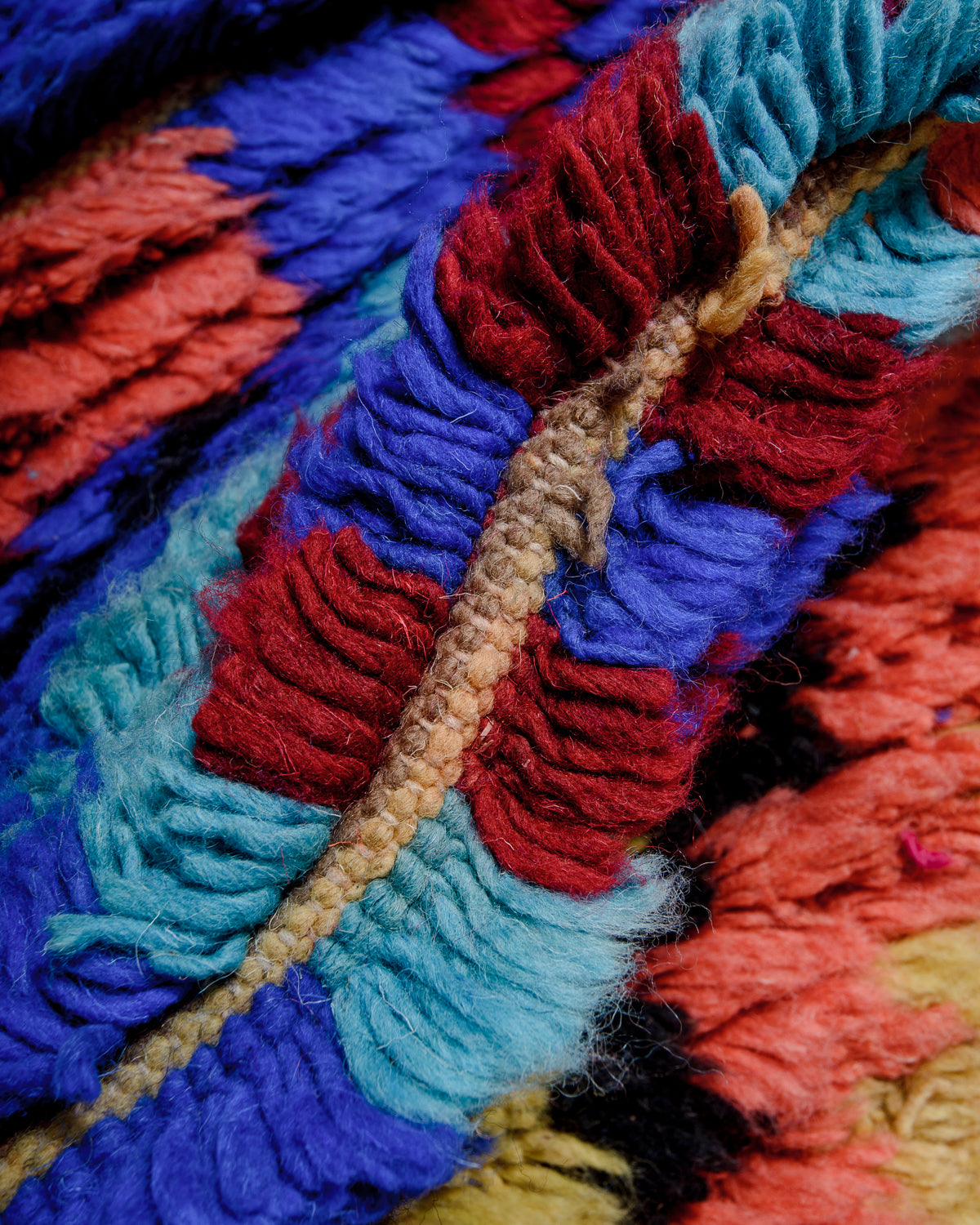 Detail of colourful berber rug showing the density of the knots and the length of the wool.