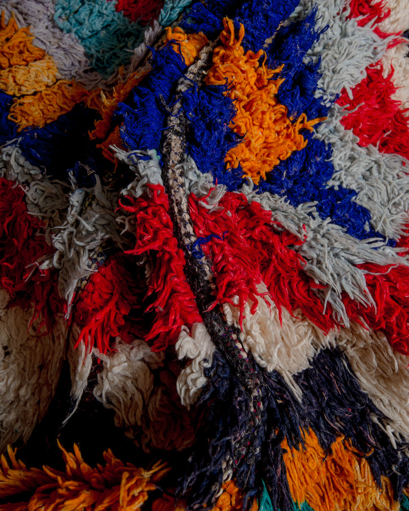 Close up of boucherouite rug with colourful cotton and fabric remnants.