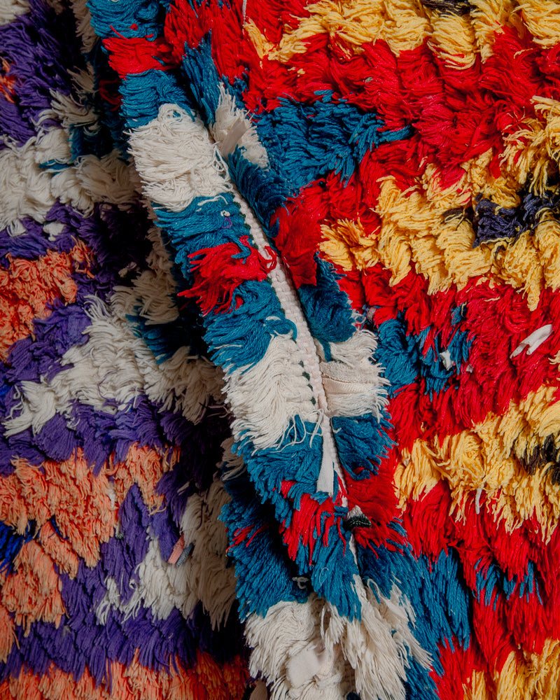 Close up of boucherouite rug with colourful cotton and fabric remnants.