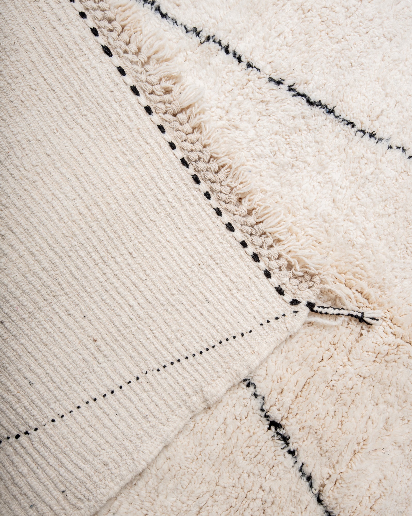 Modern, designer, handcrafted Berber rug from Morocco. Beniourain carpet with minimalist design, natural wool pile and a fluffy texture.