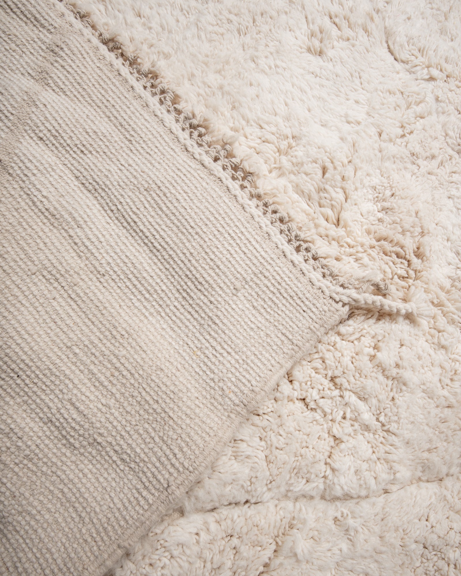 Modern, designer, handcrafted Berber rug from Morocco. Beniourain carpet with minimalist design, natural wool pile and a fluffy texture.