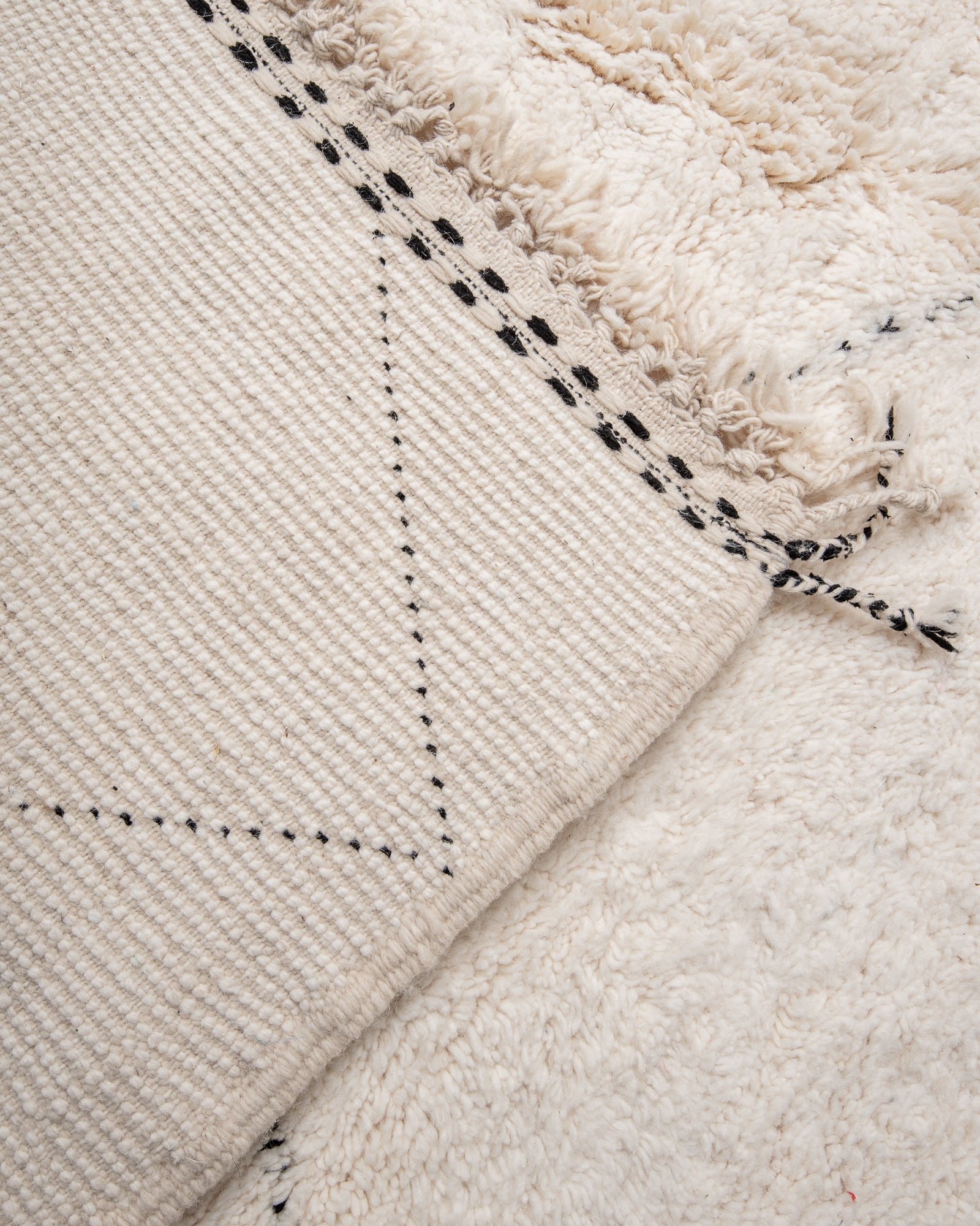 Modern, designer, handcrafted Berber rug from Morocco. Beniourain carpet with minimalist design, natural wool pile and a fluffy texture.