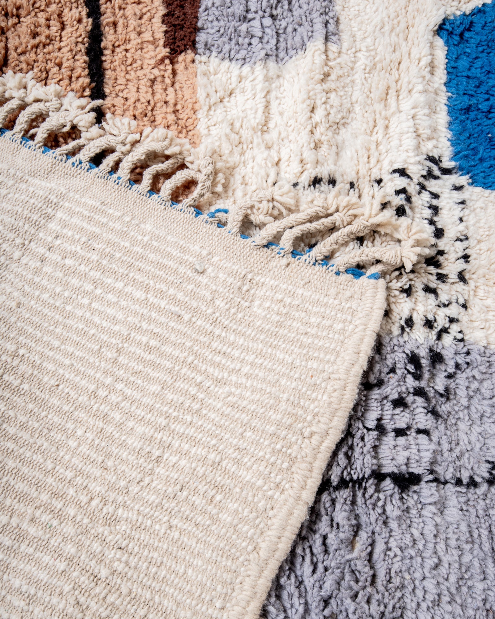 Modern, designer, handcrafted Berber rug from Morocco. Beniourain carpet with beautiful colours and patterns and fluffy wool texture.