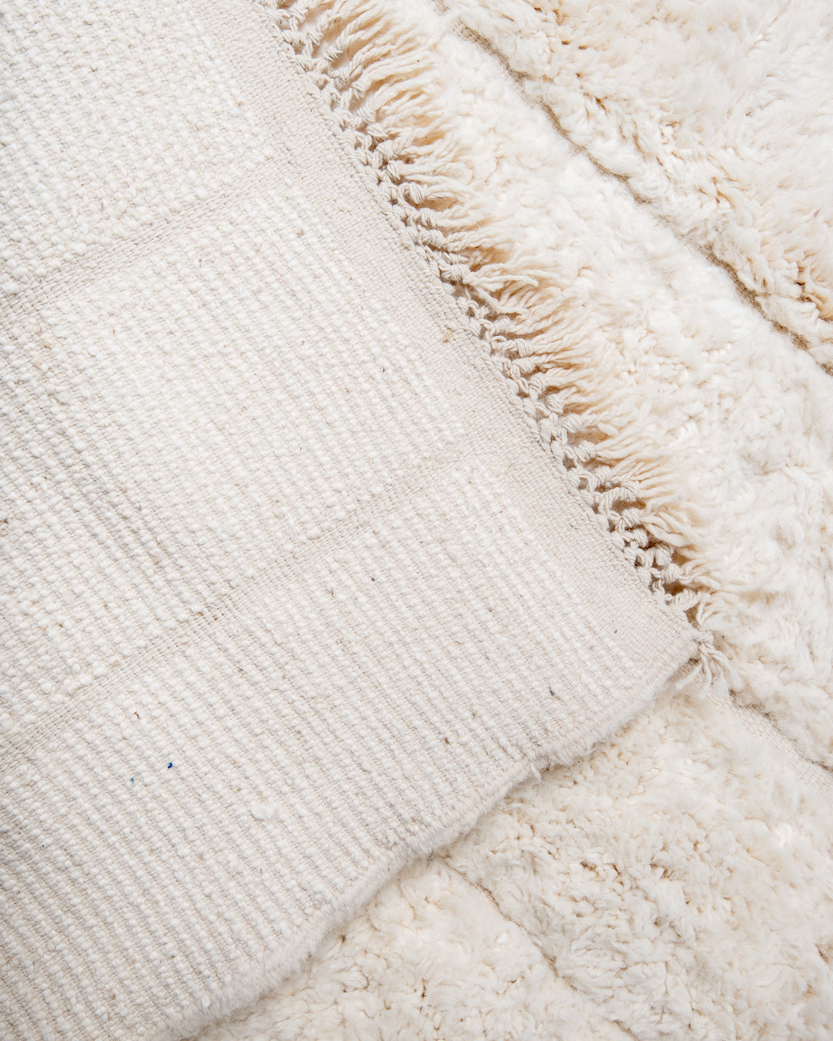 Modern, designer, handcrafted Berber rug from Morocco. Beniourain carpet with minimalist design, natural wool pile and a fluffy texture.