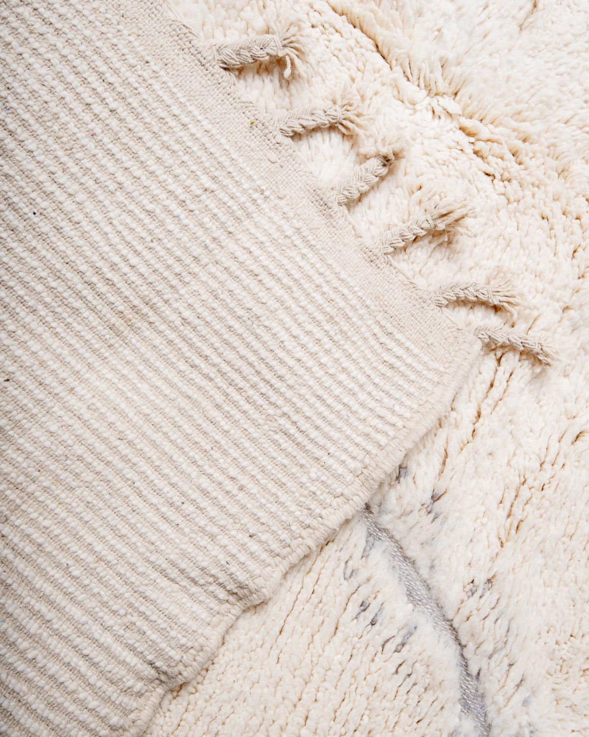 Modern, designer, handcrafted Berber rug from Morocco. Beniourain carpet with minimalist design, natural wool pile and a fluffy texture.