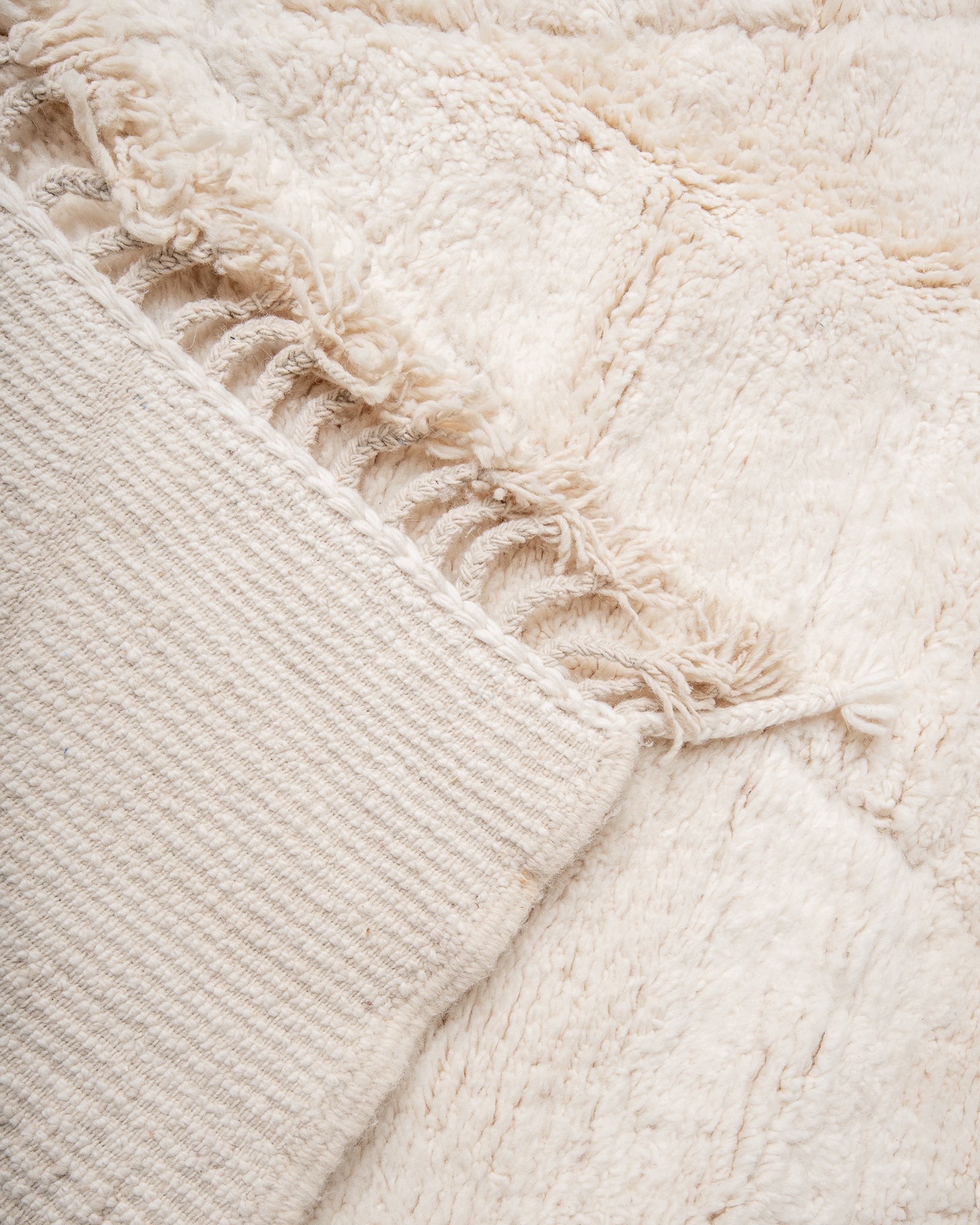 Modern, designer, handcrafted Berber rug from Morocco. Beniourain carpet with minimalist design, natural wool pile and a fluffy texture. 