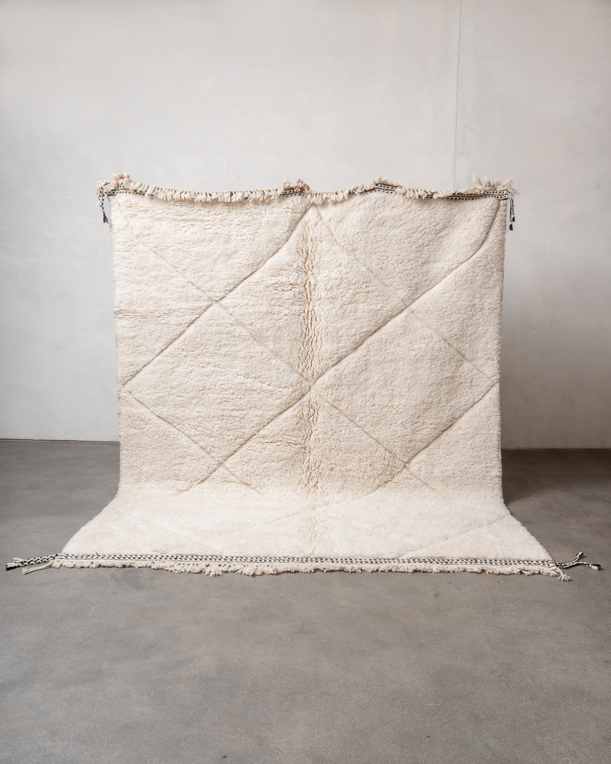 Modern, designer, handcrafted Berber rug from Morocco. Beniourain carpet with minimalist design, natural wool pile and a fluffy texture.