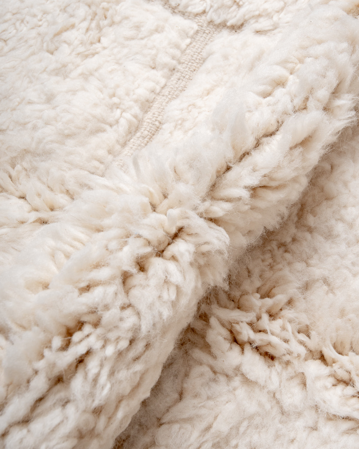 Modern, designer, handcrafted Berber rug from Morocco. Beniourain carpet with minimalist design, natural wool pile and a fluffy texture.